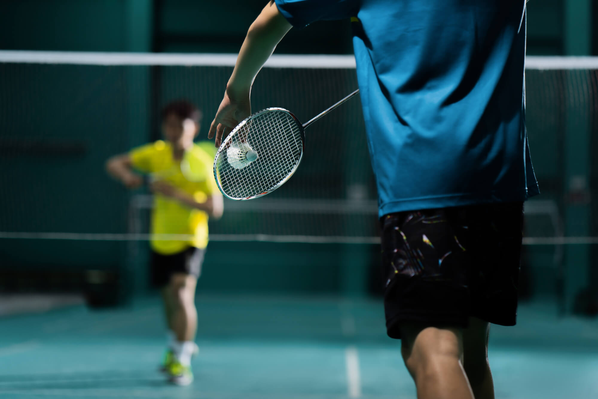 Men playing badminton - stock photo