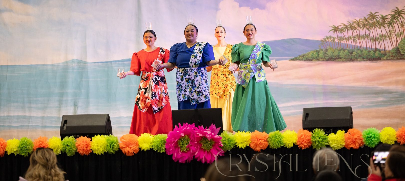 Traditional dancers perform on colorful stage.