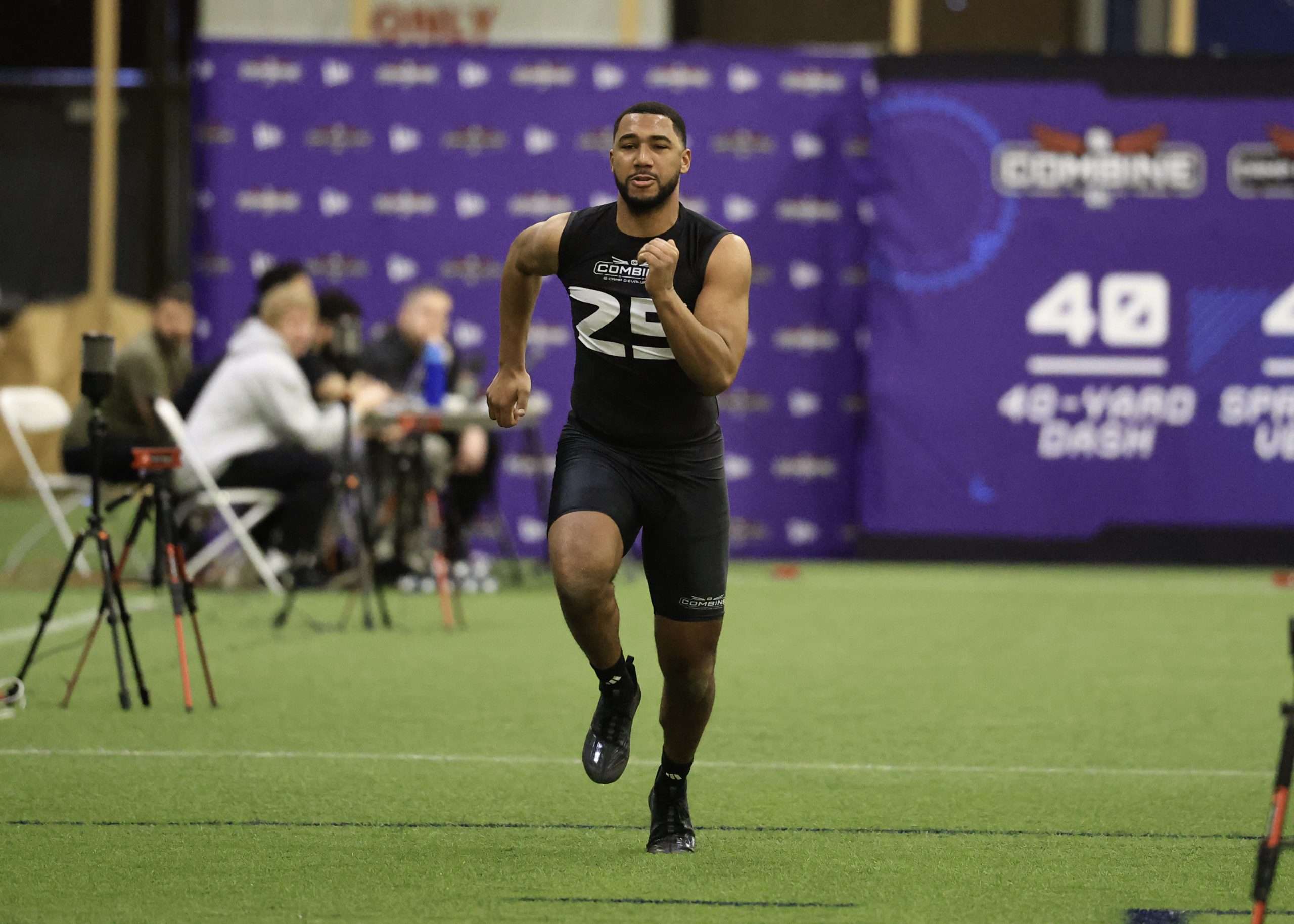 Athlete running 40-yard dash at combine event.