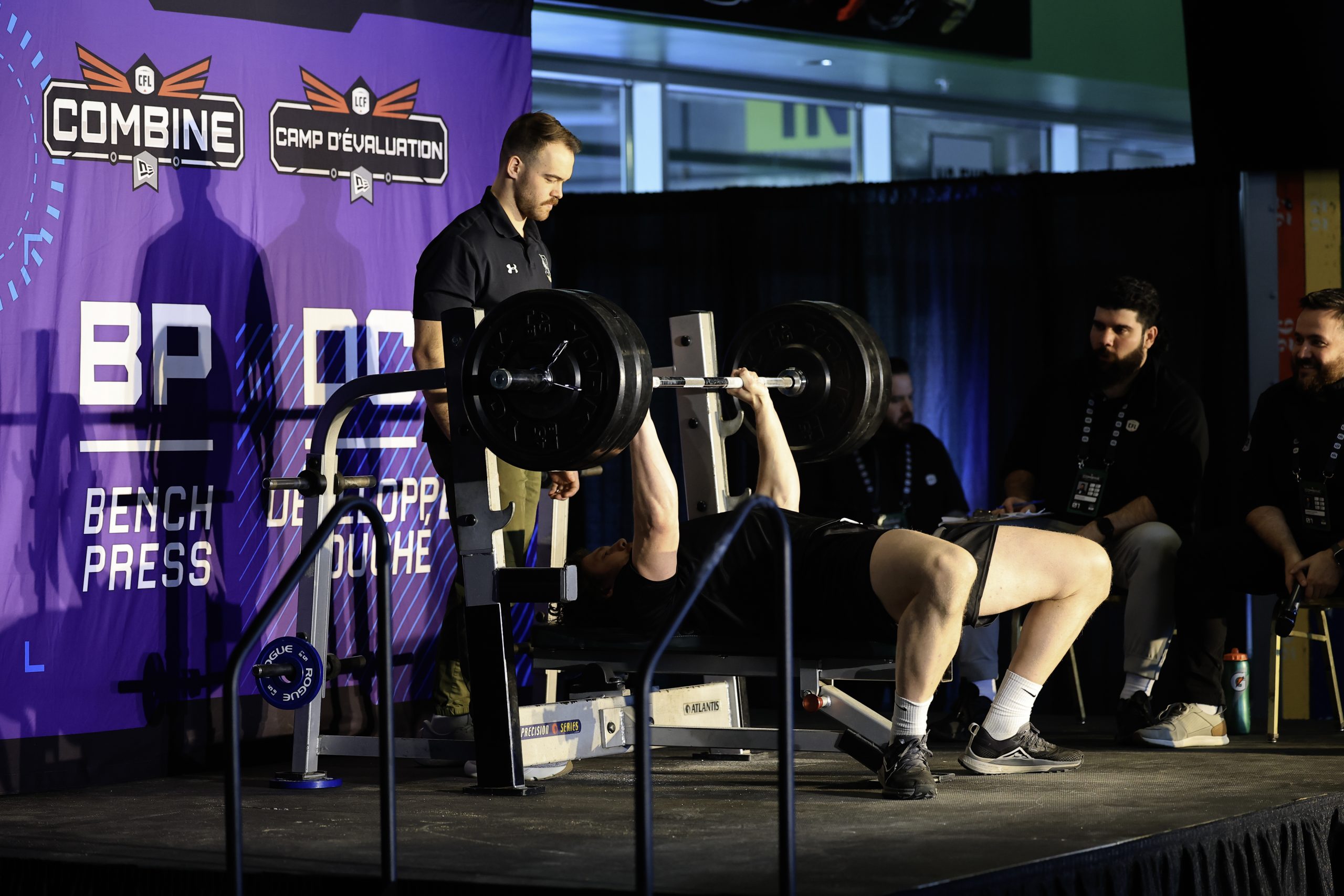 Athlete performing bench press at CFL Combine.