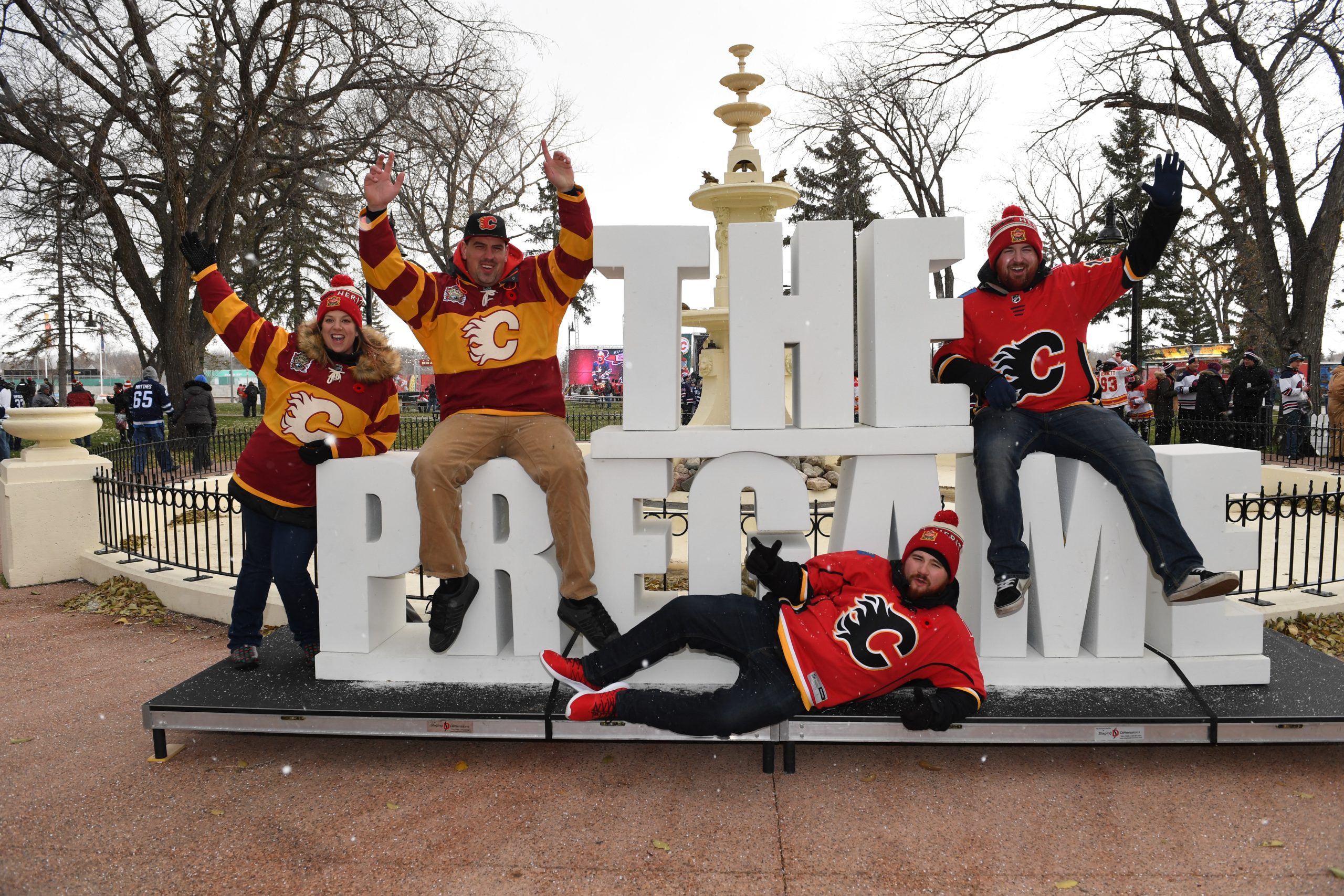 Group celebrates at outdoor hockey pregame event.